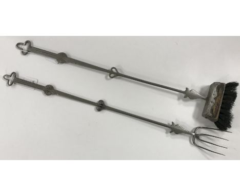 A matched pair of Cotswold Arts and Crafts fire irons comprising fork with tri-form hanging loop and dot and line engraved ha