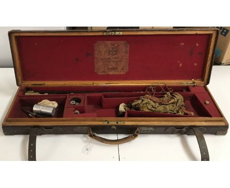A circa 1900 leather covered oak 12 bore shotgun motor case bearing label "Thomas Horsley Gunmaker York" to interior and owne