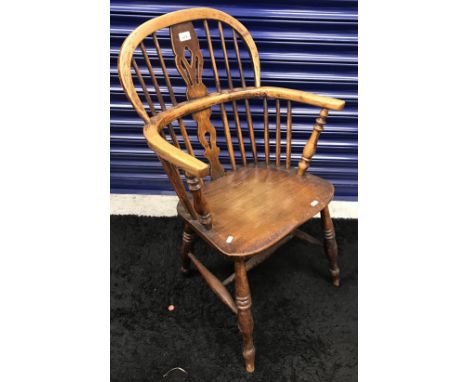 A 19th Century Thames Valley ash and elm stick back elbow chair with fretwork carved back splat, the arms on turned and ringe