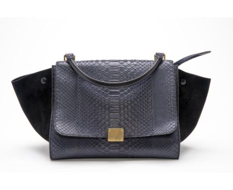 A CELINE NAVY BLUE PYTHON TRAPEZE HANDBAG
With python embossed leather and suede sides, with a top handle and removable shoul