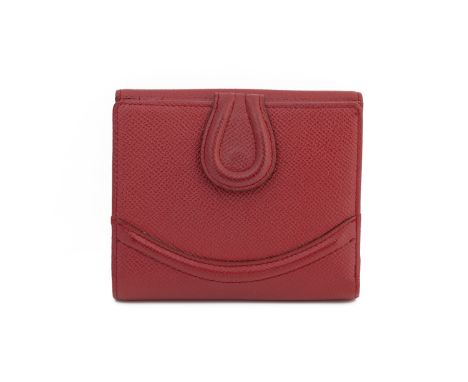 A WAKO TOKYO RED LEATHER WALLET
with a gold square repeating pattern to the interior, card holders and a button clasp.
WAKO
1