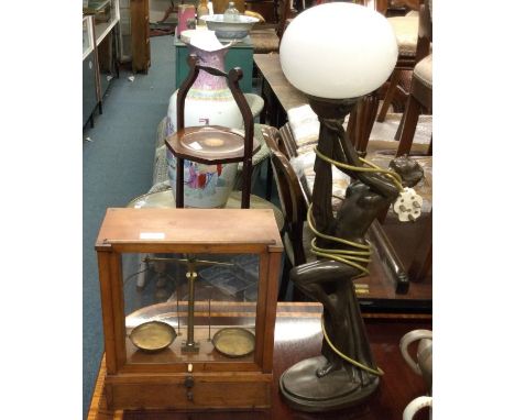 A pair of old brass scales together with a lamp.