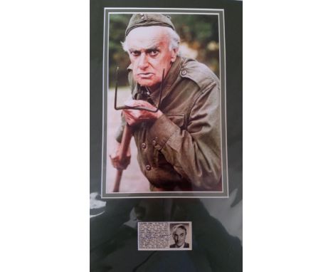 CINEMA, Dads Army, signed newspaper cutting by John Laurie, overmounted beneath colour photo from the series, 11 x 18 overall