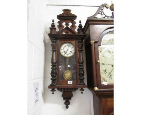 A mahogany wall clock.,