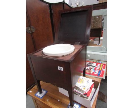A commode with original pot liner.