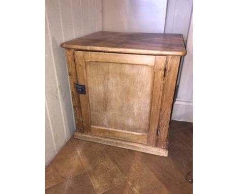 A late Victorian/Edwardian pine cupboard with panelled door opening to reveal a shelf.