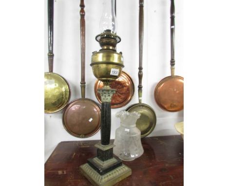 A Victorian oil lamp with shade.