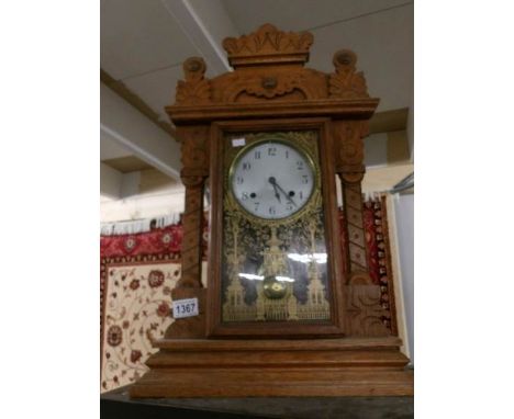 An oak cased mantel clock.