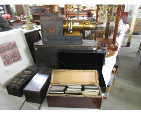 An old brass magic lantern projector in wooden box/stand and four boxes containing approximately 250 old lantern slides of mi