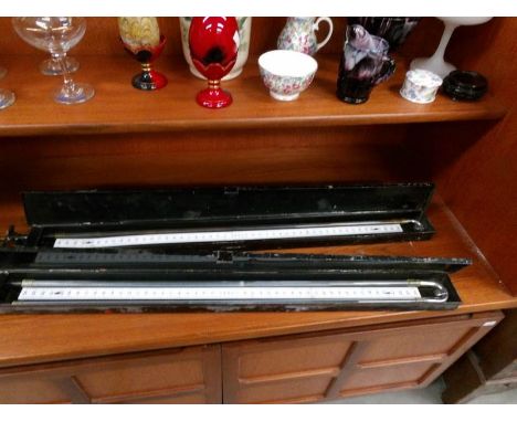 2 metal cased thermometer type instruments.