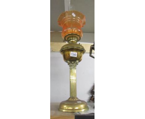 A brass Corinthian column oil lamp with shade and chimney.
