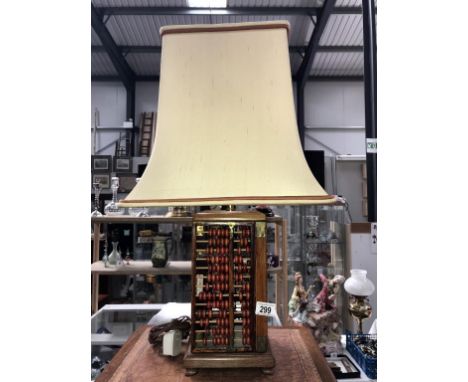 An unusual table lamp with sides in the form of abacus's and complete with shade.