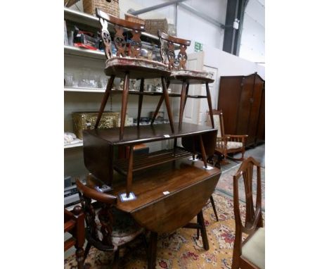 An Ercol drop leaf table and 4 chairs.