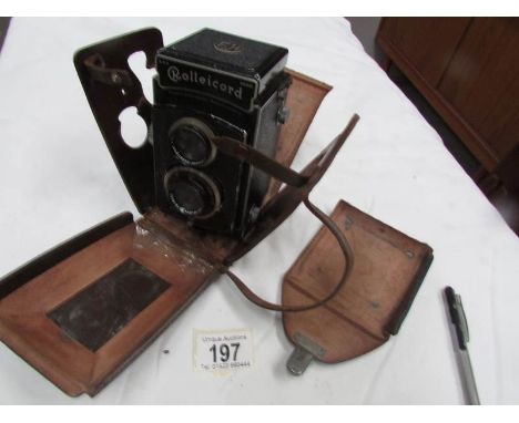 A Rolleicord Compur camera with case.