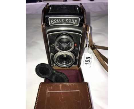 A Rolleicom camera with case.