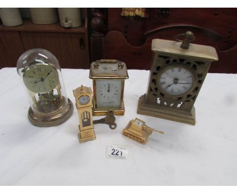 A brass carriage clock and 4 other clocks.