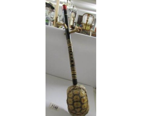 A tribal musical string instrument made with a tortoise shell,