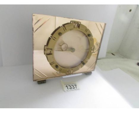 An art deco amber mirror glass mantel clock, in good working order.