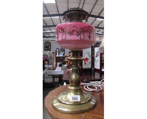 A Victorian oil lamp base with hand painted glass font.