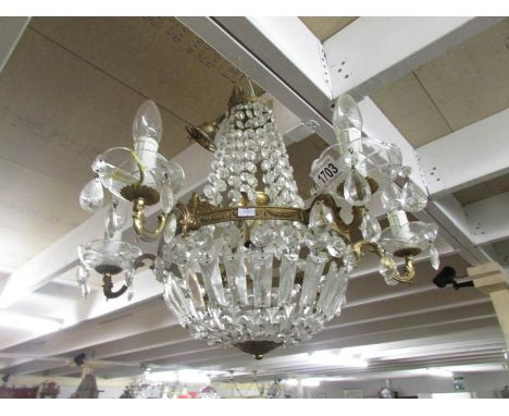 A vintage 6 lamp glass and gilded chandelier.