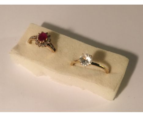 A diamond/ruby cluster ring and a white stone ring both in 9ct gold.