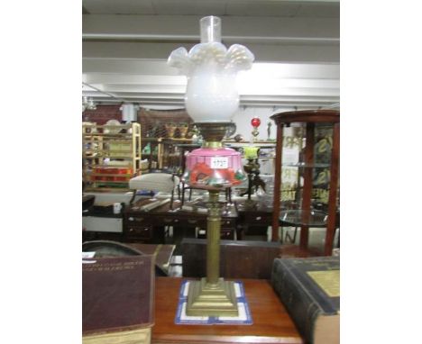 A Victorian brass Corinthian column oil lamp with pink glass font and vaseline glass shade.