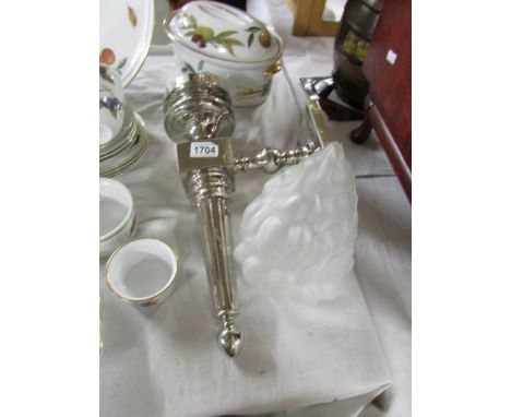 A wall light with flame shade.