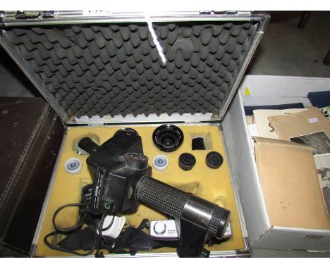 A metal camera case containing a good Minolta camera, lenses, flash etc.,