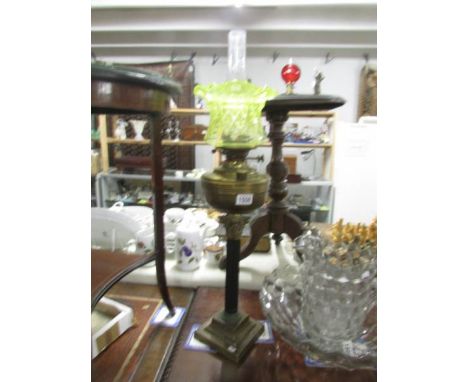 A Victorian brass Corinthian column oil lamp with shade.
