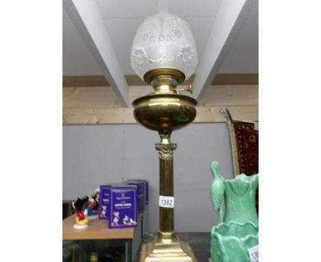 A Victorian brass Corinthian column oil lamp complete with shade and chimney.