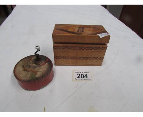 An early 20th century hand wind music box and an inlaid box containing playing cards.