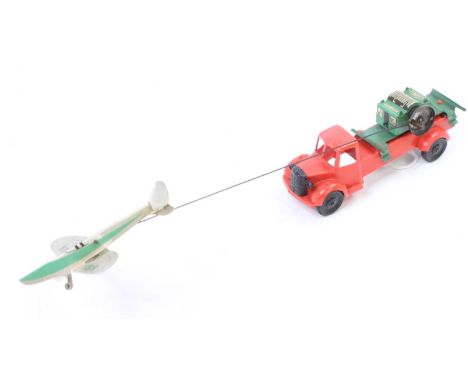 Brimtoy plastic and clockwork model of a Aircraft Transport Vehicle, comprising red body with green lithographed back, connec