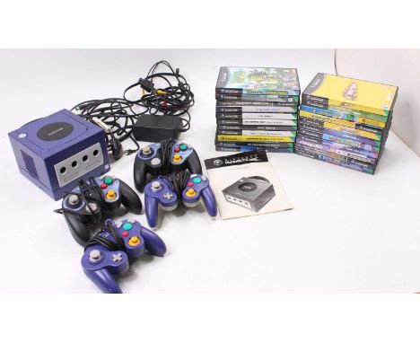 A Nintendo Gamecube console with an instruction leaflet, cables, two official controllers and two tournament pro controllers 