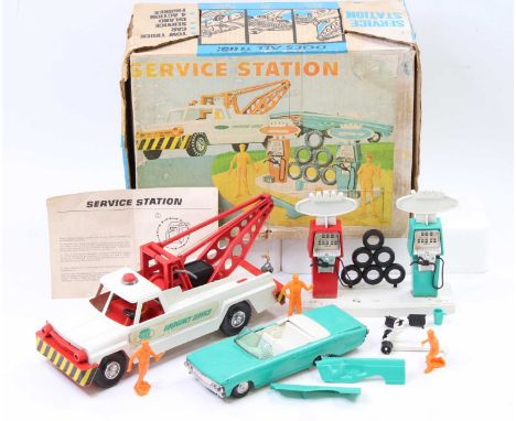 A Deluxe Topper Toys Ltd boxed service station gift set comprising of tow truck, open top car, various accessories and petrol