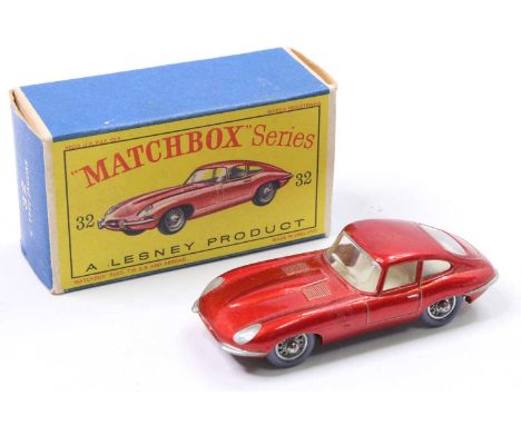 Matchbox Lesney No. 32 E Type Jaguar in metallic red with a cream interior and grey plastic tyres, the model has had some sup