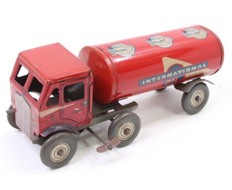 A Mettoy tin plate and clockwork model of an International Oil tractor unit and petrol tanker, comprising of red, blue and si