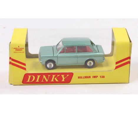 Dinky Toys No.138 Hillman Imp, metallic green body with red interior, and suitcase, housed in the original window display yel