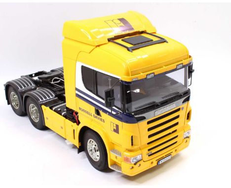 A Tamiya  plastic and radio controlled kit built model of a Scania R620 6x4 tractor unit decorated in Russell Davies livery f