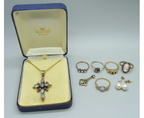 A moonstone pendant on a chain, five rings, etc., one ring lacking a stone