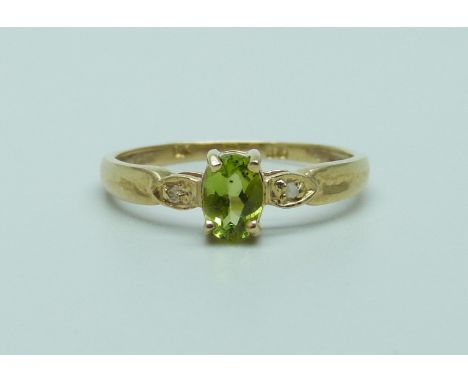 A 9ct gold ring set with an oval peridot and diamond accents, 1.1g, O