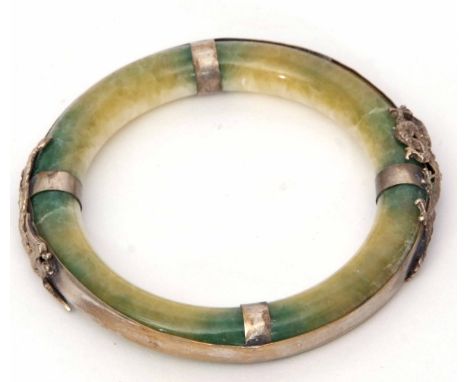 Jade type circular bangle, the surround applied with a metal dragon and mythological bird, 80mm diam  