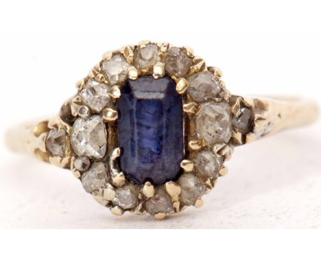 Antique sapphire and diamond cluster ring with a central rectangular shaped sapphire, within an old cut diamond surround, sta