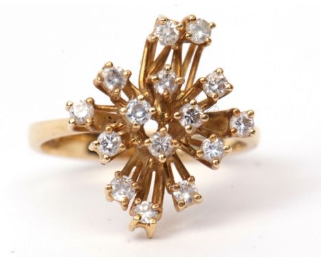 Modern diamond designer ring, featuring 15 small diamonds, each individually claw set and raised at alternate levels on wire 