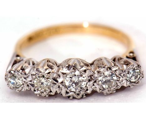 Precious metal five stone diamond ring, featuring  five graduated diamonds, all in star engraved settings and raised in a pie