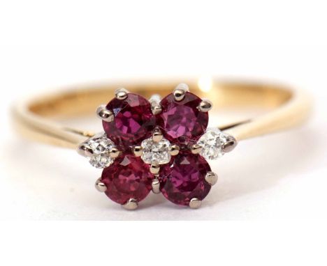 18ct ruby and diamond cluster ring featuring three small diamonds between four circular cut rubies, hallmarked London 1980, s