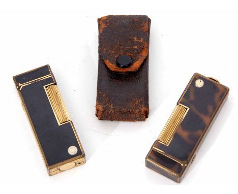Mixed Lot: comprising two various late 20th century gas cigarette lighters, both Dunhill, the first of gilt and black finishe