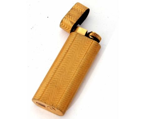 Late 20th century gold plated gas lighter, Cartier - Paris, 34093 D, the oval gilt case with all over wrythen engine turned d
