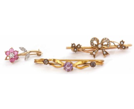 Mixed Lot: 9ct stamped bar brooch set with a seed pearl, tied ribbon and leaves design, a 9K stamped ruby and diamond flower 