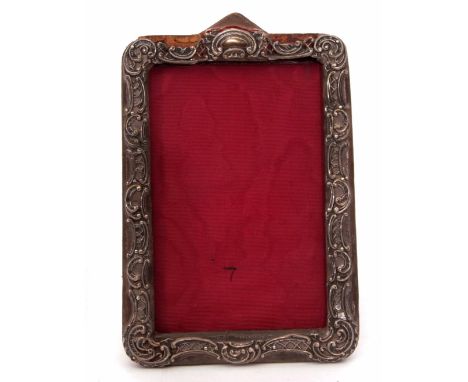 White metal mounted easel backed photograph frame, the pierced lattice work and C-scroll applied mount to a morocco covered b