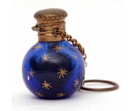 Late 19th century Continental base metal mounted scent bottle, the blue glass globular body with gilt star decoration to a fu